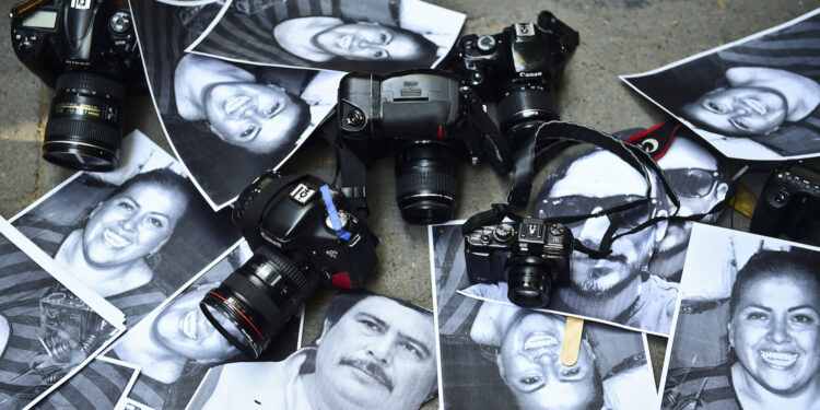 View of photos of killed journalists and cameras outside the Veracruz state representation office during a journalists protest in Mexico City on February 11, 2016. Mexican journalist Anabel Flores Salazar's funeral took place Wednesday after she was found killed at a road after being kidnapped Monday in Veracruz state, one of the most dangerous for journalists.  AFP PHOTO/RONALDO SCHEMIDT / AFP / RONALDO SCHEMIDT