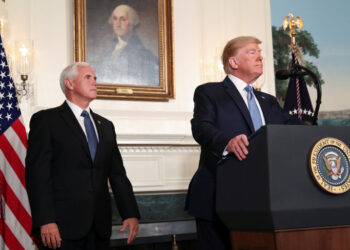 U.S. President Donald Trump speaks about the shootings in El Paso and Dayton as Vice President Mike Pence looks on in the Diplomatic Room of the White House in Washington, U.S., August 5, 2019. REUTERS/Leah Millis