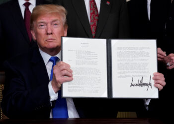 U.S. President Donald Trump holds his signed memorandum on intellectual property tariffs on high-tech goods from China, at the White House in Washington, U.S. March 22, 2018.  REUTERS/Jonathan Ernst
