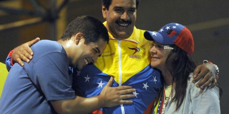 (FILES) This file picture taken on April 6, 2013 shows Venezuelan acting President Nicolas Maduro (C) embracing his wife Cilia Flores (L) and son Nicolas Maduro during a campaign rally in Puerto Ordaz, Bolivar state, Venezuela.
Nicolas Ernesto Maduro Guerra, "Nicolasito", the President's son is an economist and candidate to July 31, 2017 "constituent assembly". / AFP PHOTO / JUAN BARRETO
