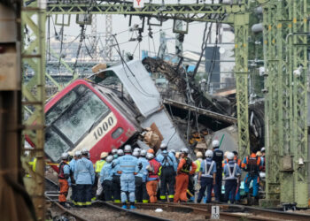 A train is seen derailed after a collision with a truck at a crossing in Yokohama, Kanagawa Prefecture on September 5, 2019. - A train and a truck collided at a crossing near Tokyo, injuring 35 people, with at least one person seriously hurt, authorities said. (Photo by Kazuhiro NOGI / AFP)