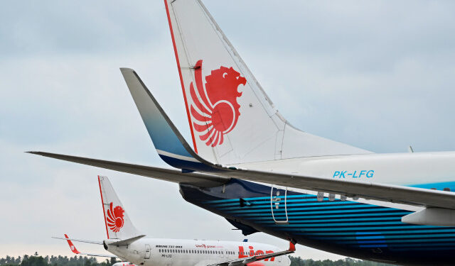 (FILES) In this file photo taken on September 3, 2019 a Lion Air Boeing 737-800 aircraft is seen at the airport in Padang, West Sumatra. - Boeing has reached settlements with 11 families of victims from October's Lion Air crash, the first agreements following two deadly crashes that killed 346 people, a plaintiffs attorney said September 25, 2019. The Wisner Law Firm, which specializes in aviation cases, is also "optimistic" about reaching settlements on its remaining six cases for families affected by the crash in Indonesia, said attorney Alexandra Wisner. (Photo by ADEK BERRY / AFP)