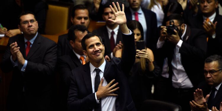 The incoming president of Venezuela's National Assembly Juan Guaido (C) waves upo arrival for the inauguration ceremony in Caracas on January 5, 2019. - The opposition-controlled National Assembly will declare illegitimate the new presidential term of Nicolas Maduro, due to start January 10, a symbolic decision that could further divide the opponents of the government. (Photo by Federico Parra / AFP)        (Photo credit should read FEDERICO PARRA/AFP/Getty Images)