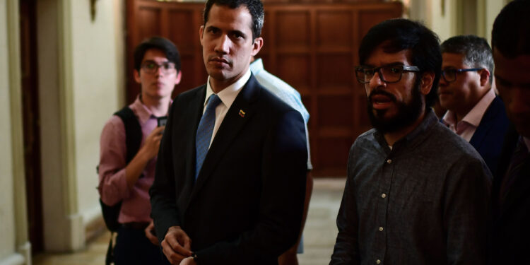 Venezuelan opposition leader and self-proclaimed acting president Juan Guaido (C) arrives to attend a session at the Venezuelan National Assembly in Caracas on March 11, 2019. - Venezuela's opposition leader Juan Guaido will ask lawmakers on Monday to declare a "state of alarm" over the country's devastating blackout in order to facilitate the delivery of international aid -- a chance to score points in his power struggle with President Nicolas Maduro. (Photo by RONALDO SCHEMIDT / AFP)        (Photo credit should read RONALDO SCHEMIDT/AFP/Getty Images)