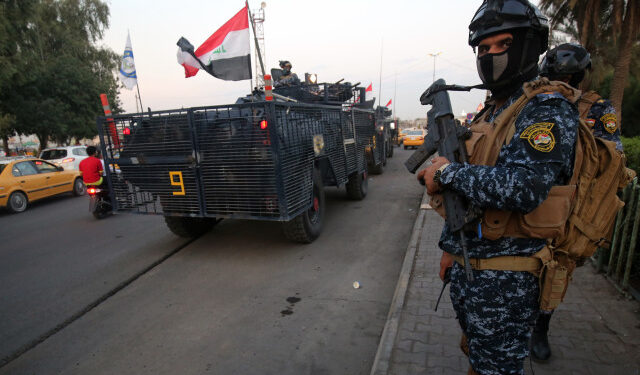 Iraqi police are seen deployed in Baghdad's predominantly Shiite Sadr City, on October 7, 2019. - Demonstrations across Baghdad and the south have spiralled into violence over the last week, with witnesses reporting security forces using water cannons, tear gas and live rounds and authorities saying "unidentified snipers" have shot at protesters and police. On Sunday evening a mass protest in Sadr City in east Baghdad led to clashes that medics and security forces said left 13 people dead. (Photo by AHMAD AL-RUBAYE / AFP)