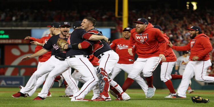 WASHINGTON, DC - OCTOBER 15: The Washington Nationals celebrate winning game four and the National League Championship Series against the St. Louis Cardinals at Nationals Park on October 15, 2019 in Washington, DC.   Patrick Smith/Getty Images/AFP