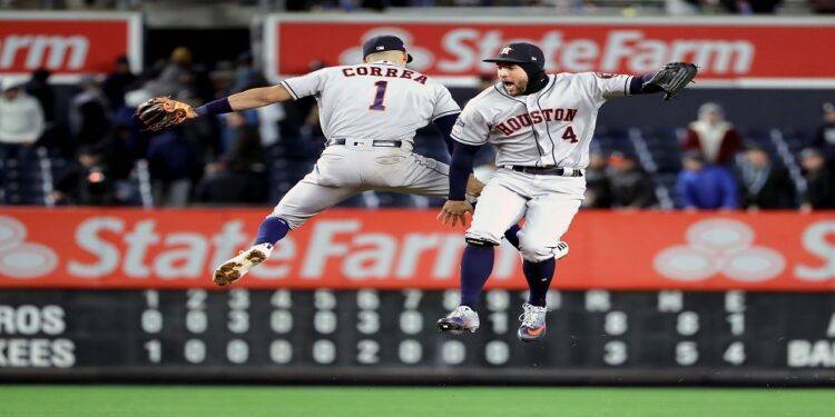 NEW YORK, NEW YORK - OCTOBER 17: Carlos Correa #1 and George Springer #4 of the Houston Astros celebrate their teams 8-3 win over the New York Yankees in game four of the American League Championship Series at Yankee Stadium on October 17, 2019 in New York City.   Elsa/Getty Images/AFP
