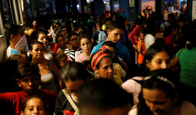 Venezuelan migrants queue at the Ecuadorian Peruvian border service center, to process their documents and be able to continue their journey, in the outskirts of Tumbes, Peru June 14, 2019. Picture taken June 14, 2019. REUTERS/Carlos Garcia Rawlins