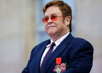 British singer-songwriter Elton John addresses a crowd in the courtyard of the Elysee Palace in Paris, on June 21, 2019, as part of a ceremony in which he was awarded the French Legion of Honour from the French president and concerts to mark France's annual "Fete de la Musique" (Music Festival). (Photo by Lewis JOLY / POOL / AFP)        (Photo credit should read LEWIS JOLY/AFP/Getty Images)