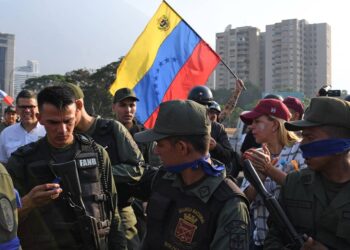 Varios civiles y militares Venezuelans en Caracas, el 30 de abril del 2019. El presidente interino Juan Guaidó y un grupo de militares que le apoyan se levantaron contra el régimen de Nicolás Maduro. YURI CORTEZ AFP/GETTY IMAGES.