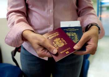 Mariana Elias, 27, shows her Venezuelan and Spanish passports at the Simon Bolivar International Airport, La Guaira, Venezuela, January 14, 2019. Before moving to Barcelona in January, Elias spent years in Caracas doing two degrees in chemical and production engineering. Her reason for moving to Barcelona was straightforward: "My job ambitions. As I really prepared myself academically, I wanted to have the opportunity in the long-term to progress and upgrade. I wasn't able to see that in Venezuela right now." REUTERS/Ana Maria Arevalo Gosen  SEARCH "AREVALO SPAIN" FOR THIS STORY. SEARCH "WIDER IMAGE" FOR ALL STORIES.