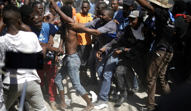 Protesters try to lynch a man who was accused of stealing their items during a protest demanding the resignation of Haitian President Jovenel Moise, in the streets of Port-au-Prince, Haiti October 28, 2019. REUTERS/Andres Martinez Casares