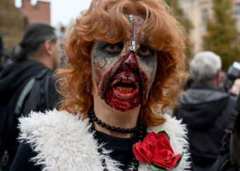 An enthusiast dressed as a zombie takes part in the traditional Zombie Parade in Kiev on October 26, 2019, to celebrate Halloween. (Photo by Sergei SUPINSKY / AFP)
