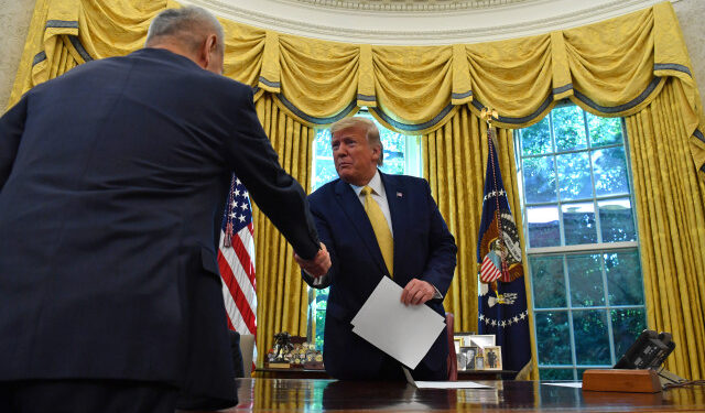 Special Envoy and Vice Premier of the People's Republic of China Liu He (L) hands over a letter of Chinese President Xi Jinping to US President Donald Trump at the Oval Office of the White House in Washington, DC on October 11, 2019. - President Donald Trump on Friday hailed a breakthrough in his drawn-out trade war with China, saying the two sides reached an initial deal covering intellectual property, financial services and currencies. (Photo by Nicholas Kamm / AFP)