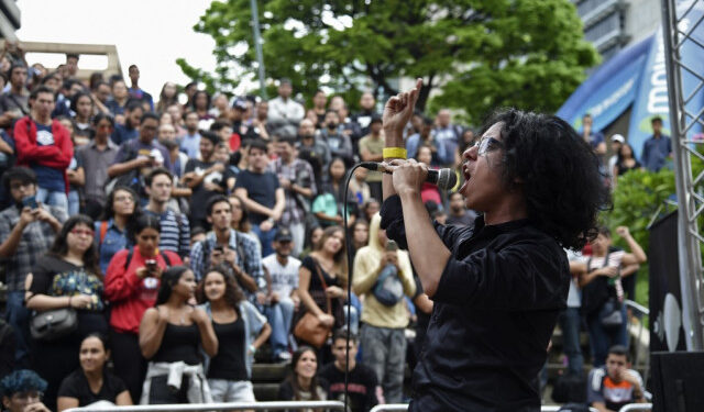 A member of a band performs during the New Bands Festival at the Altamira square in Caracas, on October 20, 2019. - The New Bands Festival is one of the few spaces which promote Venezuelan alternative musicians, for whom making music is a fight against precariousness and censorship. (Photo by Yuri CORTEZ / AFP)