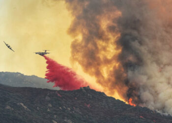 A plane drops fire retardant on a wildfire dubbed the Cave Fire at East Camino Cielo, California, U.S. November 26, 2019 in this picture obtained from social media.  Mike Eliason/Santa Barbara County Fire/via REUTERS  ATTENTION EDITORS -  THIS IMAGE HAS BEEN SUPPLIED BY A THIRD PARTY. MANDATORY CREDIT.