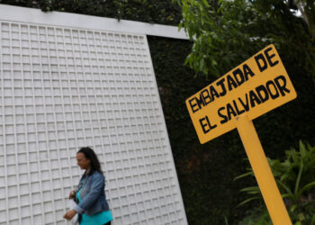 A woman walks past a sign that reads "El Salvador Embassy" in Caracas, Venezuela November 4, 2019. REUTERS/Manaure Quintero