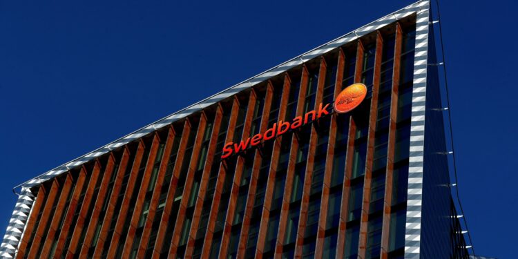 Swedbank sign is seen on the building of the bank's Lithuanian headquarters in Vilnius, Lithuania March 30, 2019. REUTERS/Ints Kalnins
