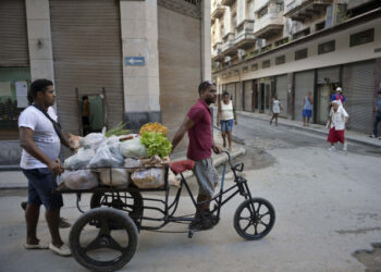 Cubans transport vegetables and fruits on a tricycle along a street in old Havana, on April 4, 2019. - A drastic reduction in the circulation of Cuban state newspapers this week, awaken the spectre of the 90s crisis, amid the shortage of basic goods, the bad news from Venezuela and the tightening of the US blockade. (Photo by YAMIL LAGE / AFP)