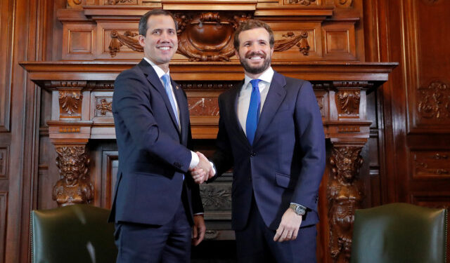Venezuela's opposition leader Juan Guaido, who many nations have recognised as the country's rightful interim ruler, shakes hands with Pablo Casado, leader of Spain's People's Party (PP), during a meeting at Casa de America in Madrid, Spain, January 25, 2020. REUTERS/Susana Vera