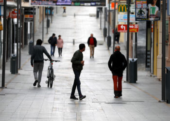People walk in the empty La Bola street, under partial lockdown as part of a 15-day state of emergency to combat the coronavirus outbreak in downtown Ronda, southern Spain, March 15, 2020. REUTERS/Jon Nazca