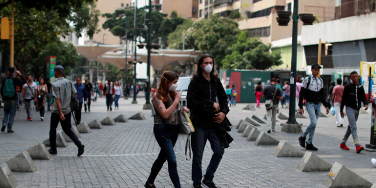 People wear protective masks in response to coronavirus (COVID-19) spread, in Caracas, Venezuela March 13, 2020. REUTERS/Carlos Jasso
