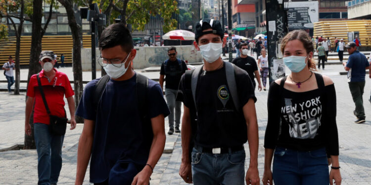 People wear protective masks in response to coronavirus (COVID-19) spread, in Caracas, Venezuela March 13, 2020. REUTERS/Carlos Jasso