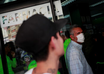 A man wears a protective mask  outside the pharmacy in response to coronavirus (COVID-19) spread in Caracas, Venezuela March 13, 2020. REUTERS/Carlos Jasso