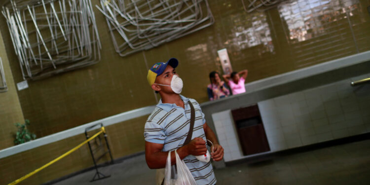 A man wears a face mask distributed by members of the Taiwan and Venezuela Parliamentary Friendship team, in response to the spreading coronavirus (COVID-19), in Caracas, Venezuela March 12, 2020. REUTERS/Carlos Jasso