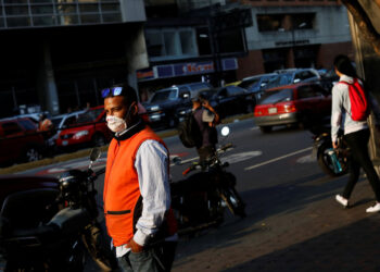 A man outside a metro station wears a face mask distributed by members of the Taiwan and Venezuela Parliamentary Friendship team, in response to the spreading coronavirus (COVID-19), in Caracas, Venezuela March 12, 2020. REUTERS/Carlos Jasso