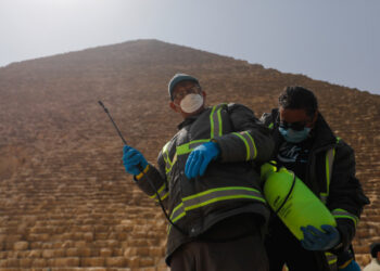 Members of the medical team prepare to spray disinfectant as a precautionary move amid concerns over the coronavirus disease (COVID-19) outbreak at the Great Pyramids, Giza, on the outskirts of Cairo, Egypt, March 25, 2020. REUTERS/Amr Abdallah Dalsh