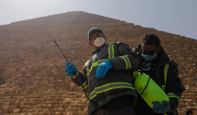 Members of the medical team prepare to spray disinfectant as a precautionary move amid concerns over the coronavirus disease (COVID-19) outbreak at the Great Pyramids, Giza, on the outskirts of Cairo, Egypt, March 25, 2020. REUTERS/Amr Abdallah Dalsh