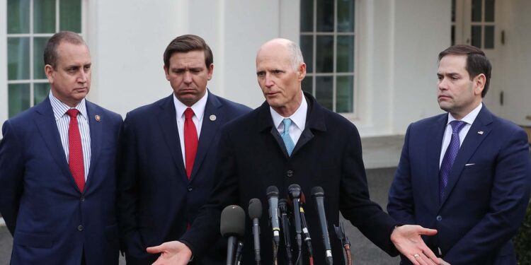 WASHINGTON, DC - JANUARY 22: Sen. Rick Scott (R-FL) speaks to the media while flanked by (L-R) Rep. Mario Diaz-Balart (R-FL), Florida Governor Ron DeSantis and Sen. Marco Rubio (R-FL), after a meeting with President Donald Trump regarding Venezuela on January 22, 2019 in Washington, DC.   Mark Wilson/Getty Images/AFP