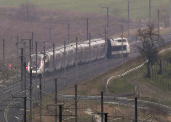 A photo shows a French high-speed TGV train which derailed after an embankment collapsed into the tracks, seriously injuring the driver and hurting 20 others, close to Ingenheim early on March 5, 2020 while travelling from the eastern city of Strasbourg to Paris. - The driver, whose injury was not specified, was evacuated by helicopter following the accident near Ingenheim, around 30 kilometres (20 miles) northwest of Strasbourg. The train was still intact but the locomotive was leaning on its side and four other wagons were also off the tracks, according to the state rail operator SNCF and AFP journalists at the scene. (Photo by Patrick HERTZOG / AFP)