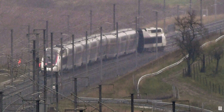A photo shows a French high-speed TGV train which derailed after an embankment collapsed into the tracks, seriously injuring the driver and hurting 20 others, close to Ingenheim early on March 5, 2020 while travelling from the eastern city of Strasbourg to Paris. - The driver, whose injury was not specified, was evacuated by helicopter following the accident near Ingenheim, around 30 kilometres (20 miles) northwest of Strasbourg. The train was still intact but the locomotive was leaning on its side and four other wagons were also off the tracks, according to the state rail operator SNCF and AFP journalists at the scene. (Photo by Patrick HERTZOG / AFP)