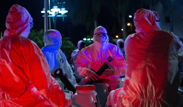 Municipal workers wearing protective gear take part in a cleaning campaign as a preventive measure against the spread of the new coronavirus COVID-19, in Caracas, on March 21, 2020. - Nearly one billion people around the world were confined to their homes Saturday as many countries implemented stay-at-home orders, and as deaths from the global coronavirus pandemic surged towards 13,000. (Photo by Cristian HERNANDEZ / AFP)