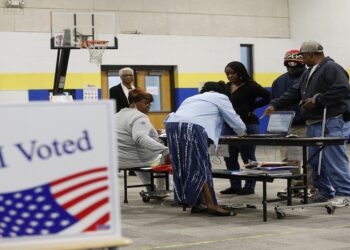 Voters check-in with poll workers at a polling station located at Mary Ford Elementary School during the primary election in North Charleston, South Carolina, on February 29, 2020. (Photo by Joshua Lott / AFP)