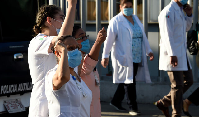 Health workers demonstrate demanding medical material to care for COVID-19 patients, in Mexico City on April 13, 2020. (Photo by ALFREDO ESTRELLA / AFP)