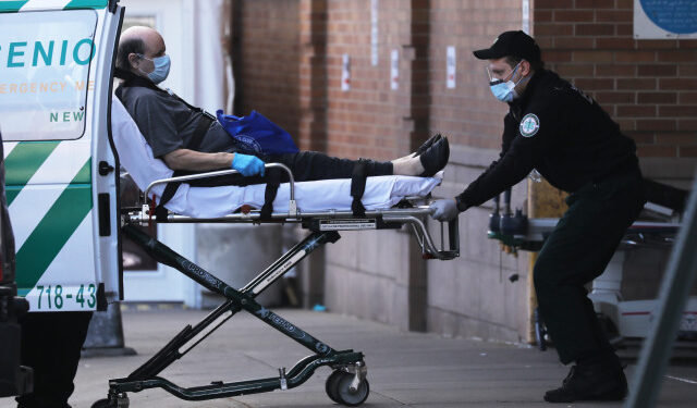 NEW YORK, NY - APRIL 21: Medical workers transport a patient outside of a special coronavirus intake area at Maimonides Medical Center on April 21, 2020 in the Borough Park neighborhood of the Brooklyn borough of New York City. Hospitals in New York City, which have been especially hard hit by the coronavirus, are just beginning to see a downturn in COVID-19 cases.   Spencer Platt/Getty Images/AFP