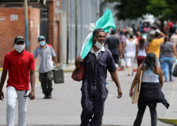 A man walks on the street with his face unprotected during the national quarantine in response to the spread of coronavirus disease (COVID-19) in Caracas, Venezuela, March 21, 2020. REUTERS/Manaure Quintero