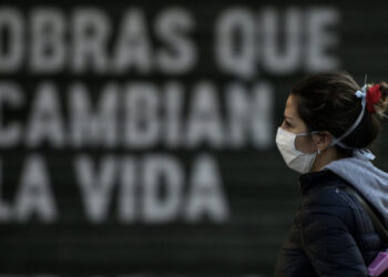 A woman wears a face mask in Buenos Aires, on April 17, 2020 amid the COVID-19 coronavirus pandemic. (Photo by JUAN MABROMATA / AFP)