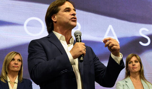The presidential candidate for Uruguay's Partido Nacional party, Luis Lacalle Pou gestures flanked by his wife Lorena Ponce de Leon (R) and his vice-presidential candidate Beatriz Argimon, while addressing supporters in Montevideo after polls closed in the country's general election on October 27, 2019. - The leftist ruling coalition's presidential candidate Daniel Martinez was ahead in Uruguay's general election, according to early results, but is set for a run-off on November 24 against former senator Luis Lacalle Pou of the National Party, who was running second with 30 percent. (Photo by EITAN ABRAMOVICH / AFP)