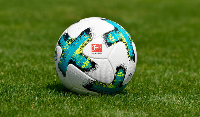 (FILES) In this file photo taken on August 01, 2017 a ball with the logo of the German first division football league Bundesliga is seen on the pitch during a team presentation of the German first division Bundesliga football team SC Freiburg in Freiburg, southwestern Germany. - The German government and state leaders gave the Bundesliga the green light to restart behind closed doors in mid-May after weeks of shutdown imposed to control the spread of the coronavirus. (Photo by THOMAS KIENZLE / AFP)