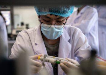 A worker is seen inside the Beijing Applied Biological Technologies (XABT) research and development laboratory in Beijing on May 14, 2020. - XABT is a Chinese company specializing in developing pathogens diagnostics, among them reagent kits for the COVID-19 coronavirus. (Photo by NICOLAS ASFOURI / AFP)