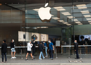 Employees assist customers wearing protective masks while they wait in-line at an Apple Inc. store reopening, after being closed due to lockdown measures imposed because of the coronavirus, in the Bondi Junction suburb of Sydney, Australia, on Thursday, May 7, 2020. Apple's app store saw its strongest month of growth in two and a half years in April, according to Morgan Stanley, which wrote that "all major regions & categories saw accelerating spend" as a result of the pandemic. Photographer: Brendon Thorne/Bloomberg