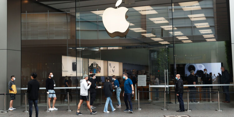 Employees assist customers wearing protective masks while they wait in-line at an Apple Inc. store reopening, after being closed due to lockdown measures imposed because of the coronavirus, in the Bondi Junction suburb of Sydney, Australia, on Thursday, May 7, 2020. Apple's app store saw its strongest month of growth in two and a half years in April, according to Morgan Stanley, which wrote that "all major regions & categories saw accelerating spend" as a result of the pandemic. Photographer: Brendon Thorne/Bloomberg