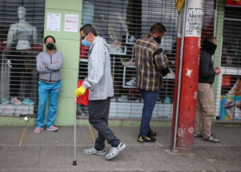 A man wearing a face mask walks down a street with a cane during the mandatory isolation decreed by the Colombian government as a preventive measure against the spread of the coronavirus disease (COVID-19) in Soacha, Colombia March 31, 2020. REUTERS/Luisa Gonzalez