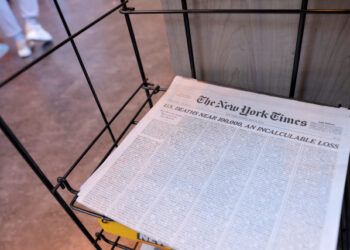 The cover of The New York Times, featuring a headline regarding the approaching 100,000th death of the coronavirus disease (COVID-19), is seen for sale in Manhattan, New York City, U.S., May 24, 2020. REUTERS/Andrew Kelly