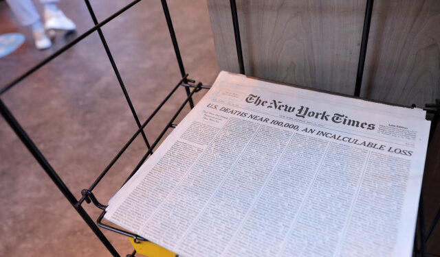 The cover of The New York Times, featuring a headline regarding the approaching 100,000th death of the coronavirus disease (COVID-19), is seen for sale in Manhattan, New York City, U.S., May 24, 2020. REUTERS/Andrew Kelly