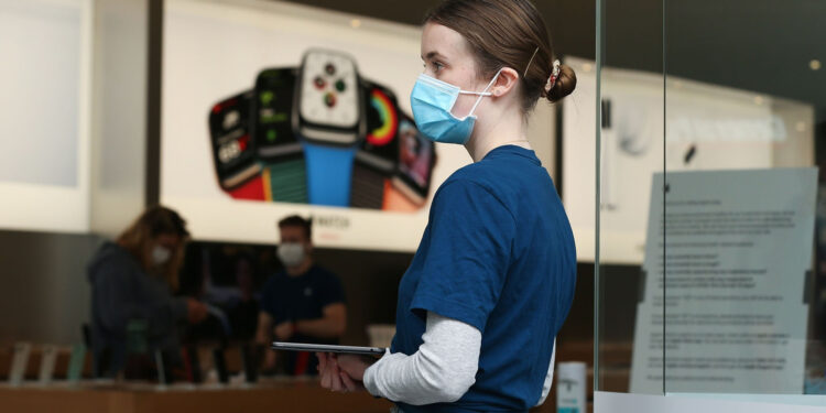 An employee wears a protective mask at an Apple Inc. store reopening, after being closed due to lockdown measures imposed because of the coronavirus, in the Bondi Junction suburb of Sydney, Australia, on Thursday, May 7, 2020. Apple's app store saw its strongest month of growth in two and a half years in April, according to Morgan Stanley, which wrote that "all major regions & categories saw accelerating spend" as a result of the pandemic. Photographer: Brendon Thorne/Bloomberg